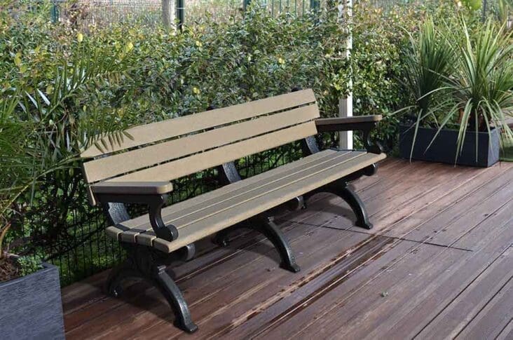 The 6 ft Silhouette Bench with arms shown with weathered wood planks and decorative black base frames.